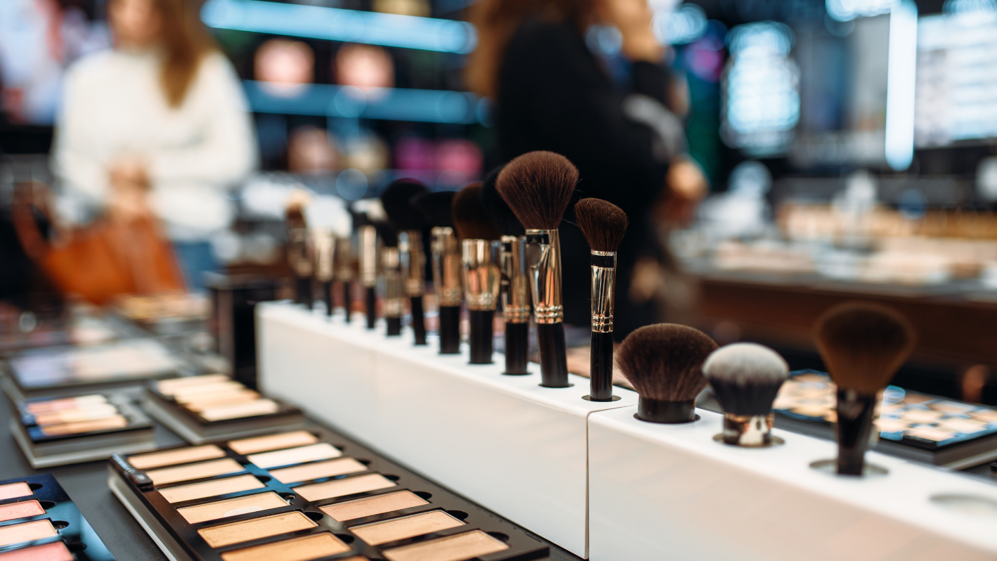 Makeup brushes and eyeshadow palettes displayed in a cosmetics store