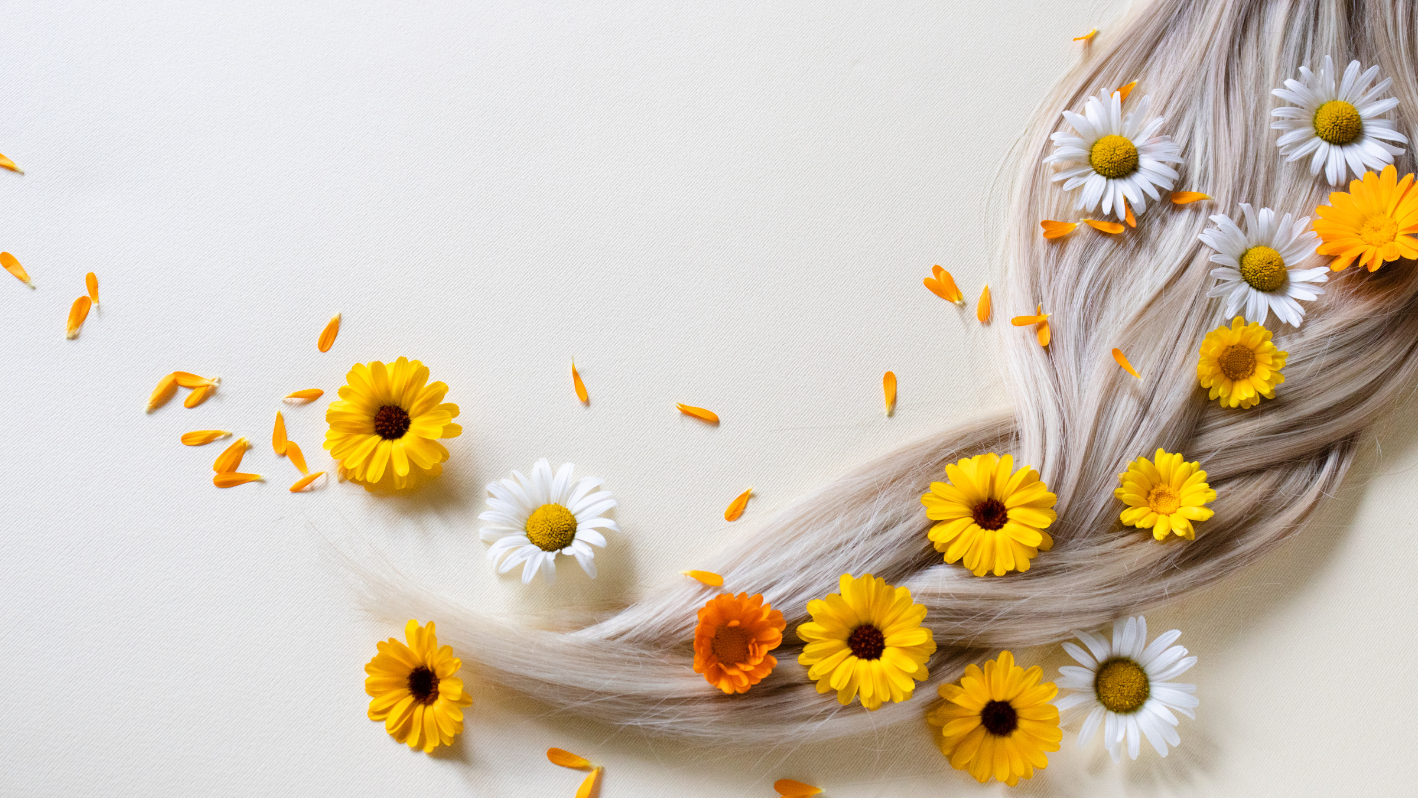 Blonde hair with yellow and white daisies scattered on light background